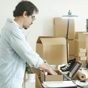 Man putting item on the box