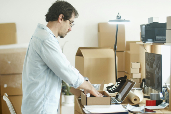 Man putting item on the box