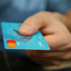 Person holding debit card